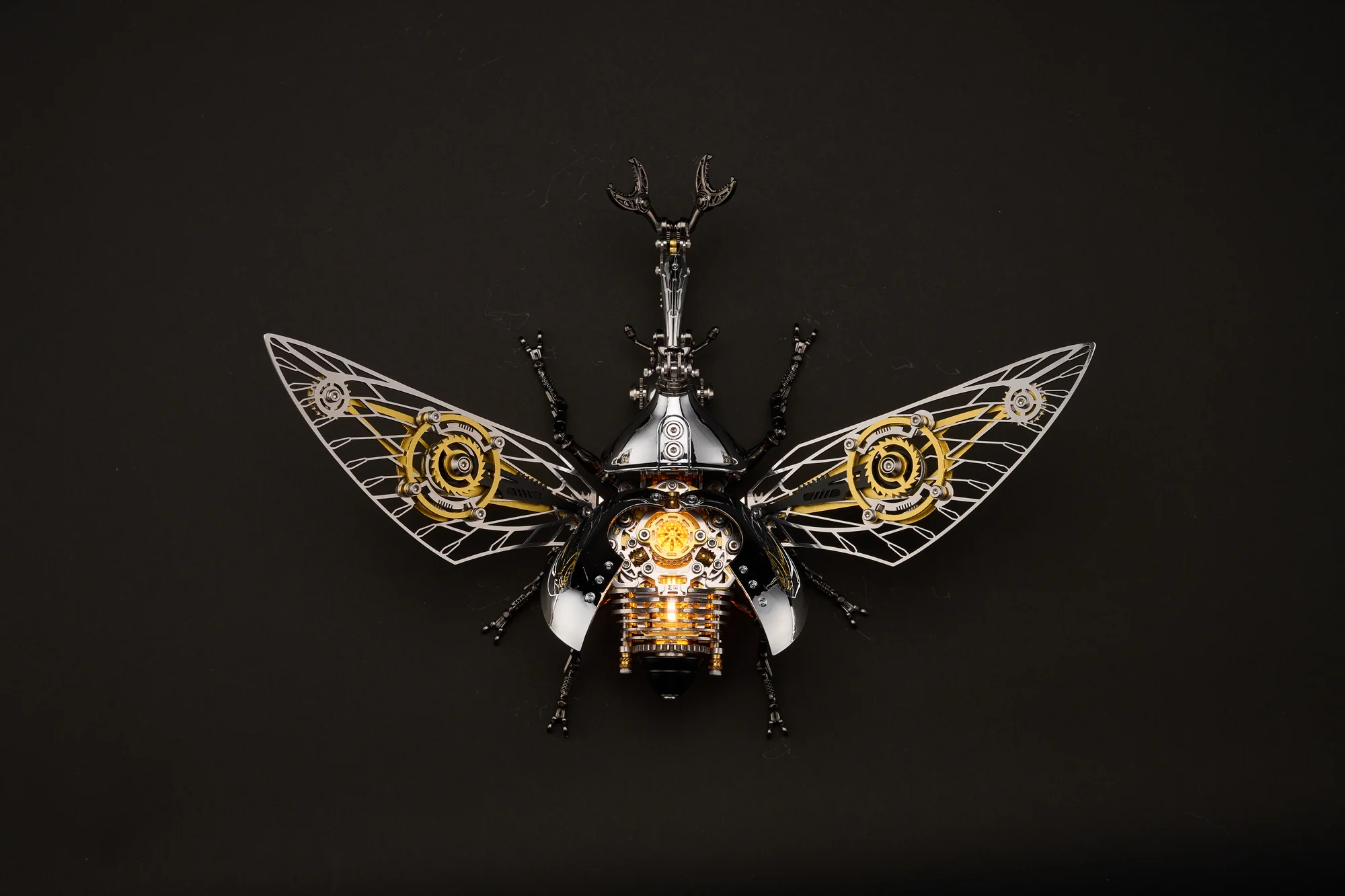 Silver mechanical Rhinoceros Beetle with open wings and gold details